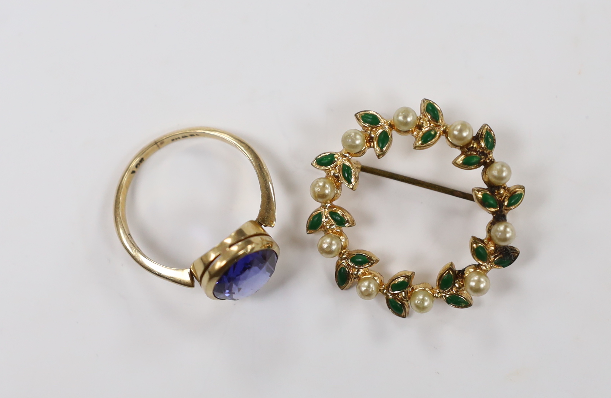 A 9ct and oval cut synthetic sapphire set ring, size P/Q, together with a costume brooch.